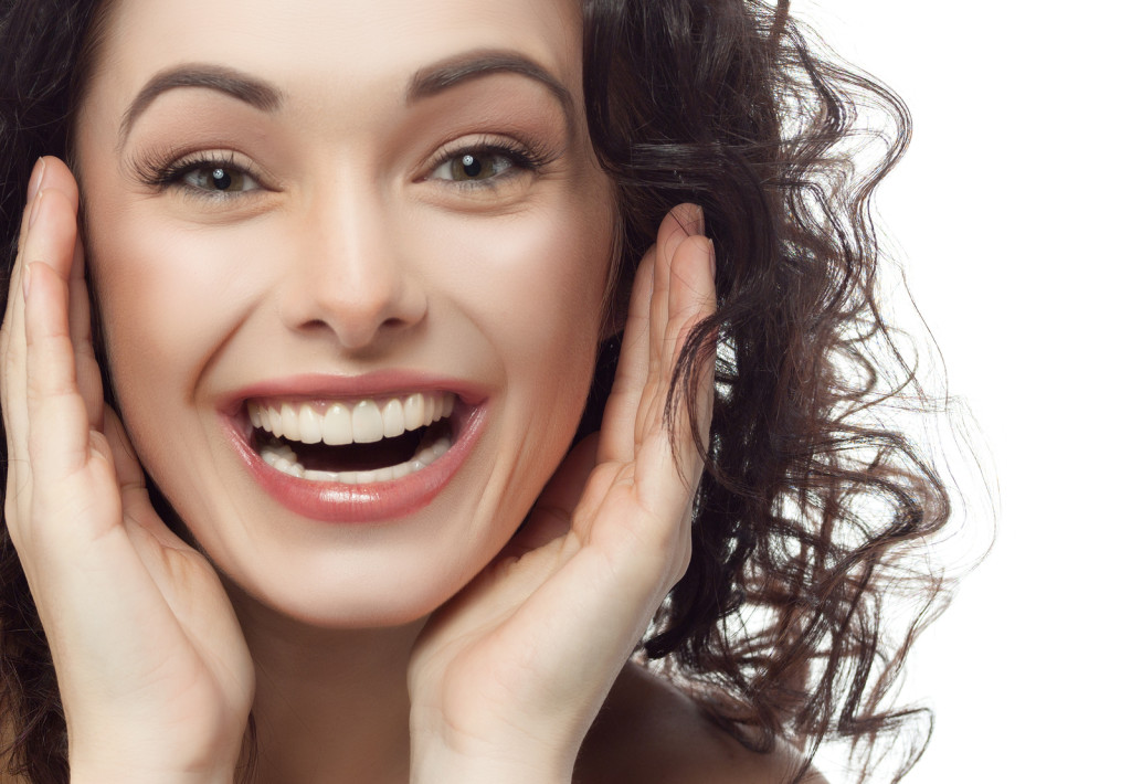 closeup portrait of attractive caucasian smiling woman brunette - dentist in raleigh